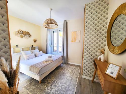 a bedroom with a bed and a mirror at Hacienda -A 2 min de la plage in Saint Malo