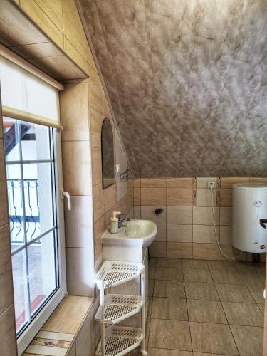 a small bathroom with a sink and a window at Michałek w Rowach in Rowy
