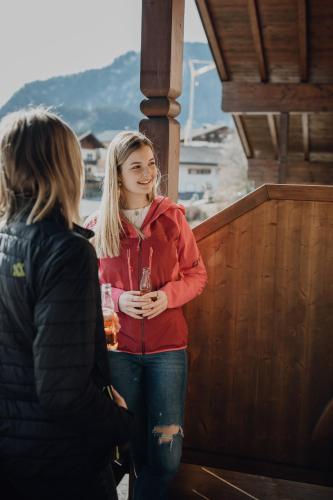 two women standing next to each other on a porch at Dorfcafe Unken Hotelpension sWirtshaus im Dorf in Unken