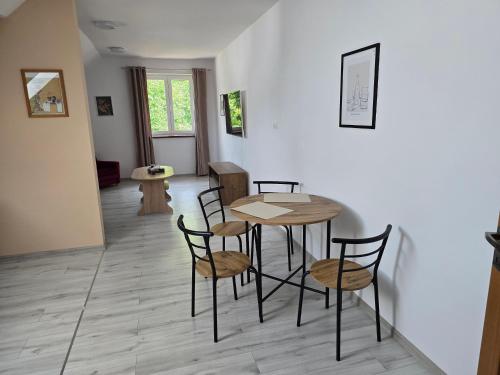 a dining room with a table and chairs at Apartmán pod Javorovým vrchem in Nebory