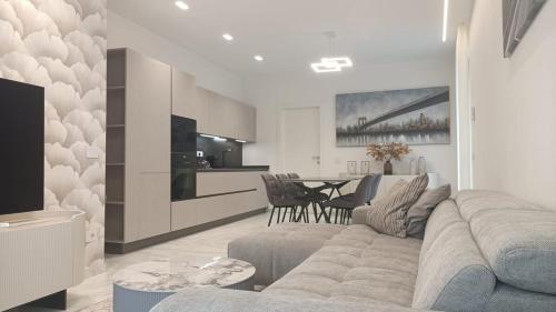 a living room with a couch and a table at Holiday home Varese in Varese