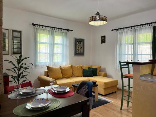 a living room with a couch and a table at Rustična kuća CRVENA STENA u blizini kućice na Drini in Bajina Bašta