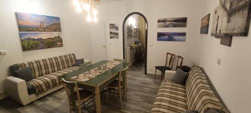 a living room with a couch and a table at A ca' vostra in Villanova dʼAsti