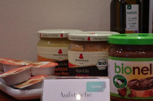 a refrigerator filled with jars of peanut butter and jelly at Hotel an der Therme in Bad Dürkheim