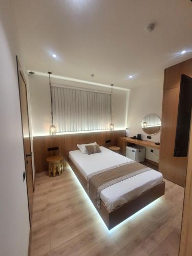 a bedroom with a large bed and a television at Sarhad Hotel in Bukhara