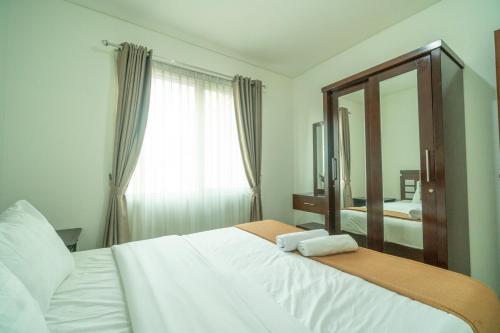 Ένα ή περισσότερα κρεβάτια σε δωμάτιο στο Peaceful 2BR Near Mall Thamrin, SCBD Netflix