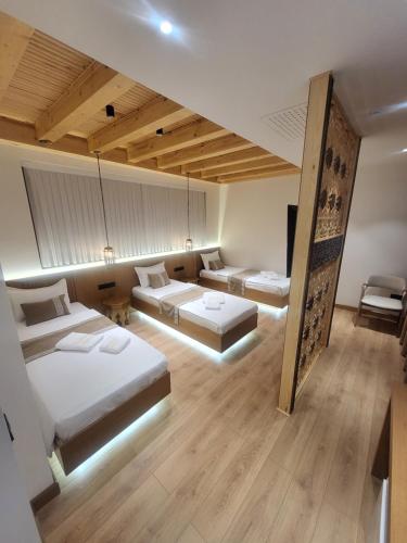 a large room with two beds and a couch at Sarhad Hotel in Bukhara