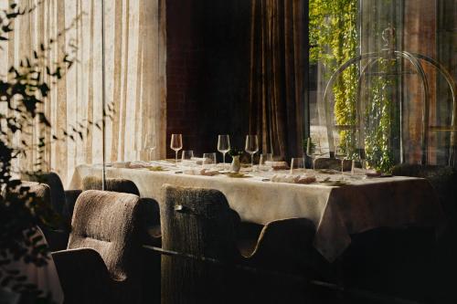 a long table with wine glasses on top of it at Hotel Blow Up Hall in Poznań