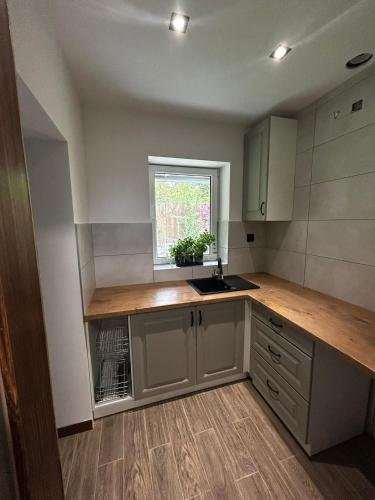 a kitchen with a counter and a sink and a window at Domek przy Rozpadlisku 2 in Podgórzyn