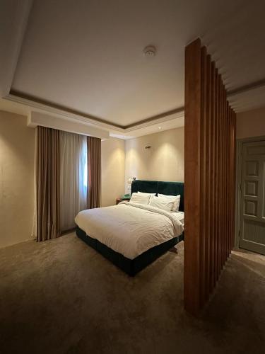 a bedroom with a bed and a window at Quiet Zoon in Jeddah