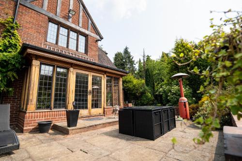 a large brick house with a large window at Chimneys Hot Tub Country Escape in Stourbridge