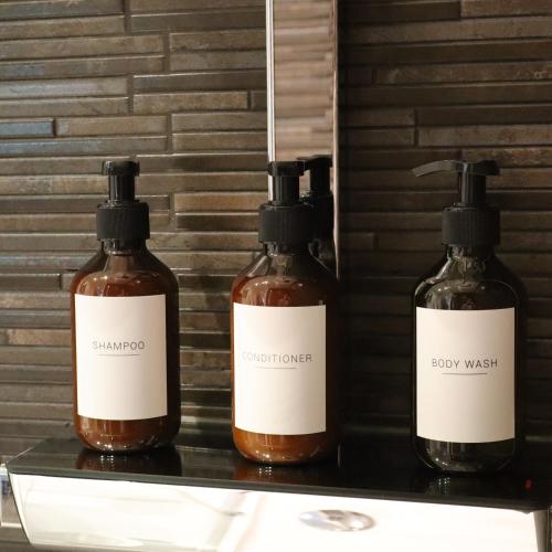 three bottles of soap sitting on a shelf at Chimneys Hot Tub Country Escape in Stourbridge