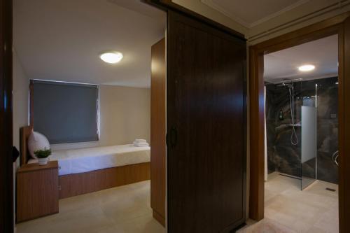 a bathroom with a shower and a glass door at Aegean Breeze House in Nea Iraklia