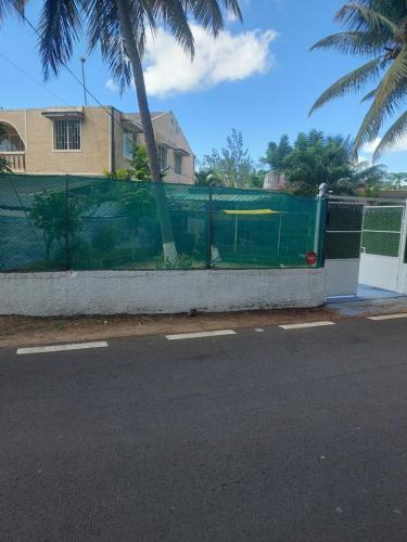 a fence on the side of a street at Studio de la plage d'Albion in Mauritius