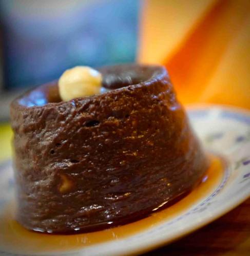 a piece of chocolate dessert with a banana on a plate at Alpuntogiusto in Peveragno