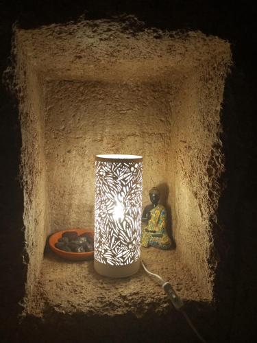 a vase sitting on a shelf with a candle at Eco-Finca Azuay - Cave refuge in Santa Cruz de Tenerife