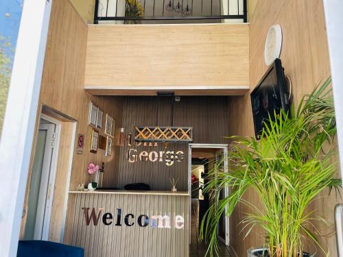 a building with a welcome sign on the side of it at Henry George Hotel in Pretoria