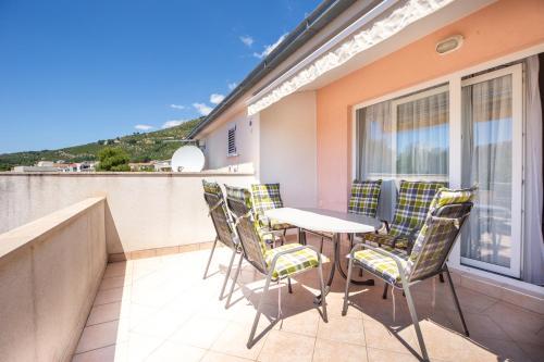 a patio with a table and chairs on a balcony at Villa Alesa Steva in Tučepi