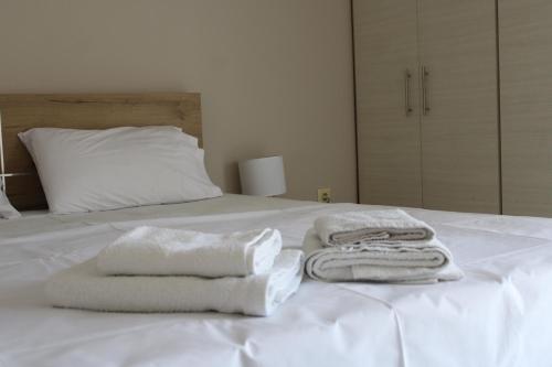 a white bed with towels on top of it at Dream House 3 in Xanthi