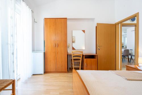 a bedroom with a bed and a kitchen with a table at Villa Alesa Steva in Tučepi