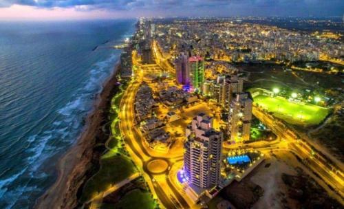an aerial view of a beach at night at Vila first line to the sea in Netanya