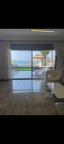 a room with a view of a table and an umbrella at Vila first line to the sea in Netanya