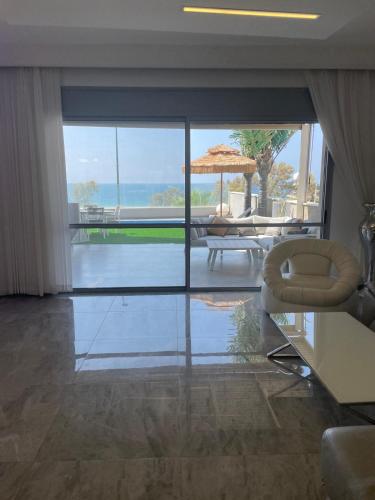 a living room with a view of the ocean at Vila first line to the sea in Netanya