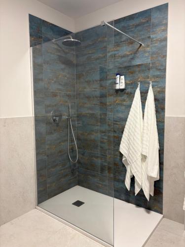 a bathroom with a shower with a glass door at Vivic Attic Monforte in Monforte dʼAlba