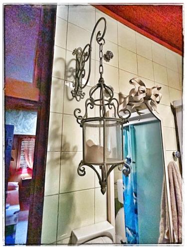 a bathroom with a chandelier hanging over a toilet at Holiday Home Nature Neno in Visoko