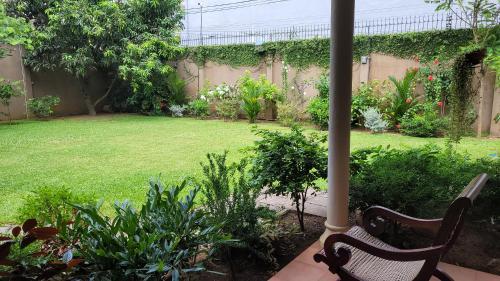 a patio with two chairs and a garden at Spacious and Serene Family Home in Colombo in Colombo