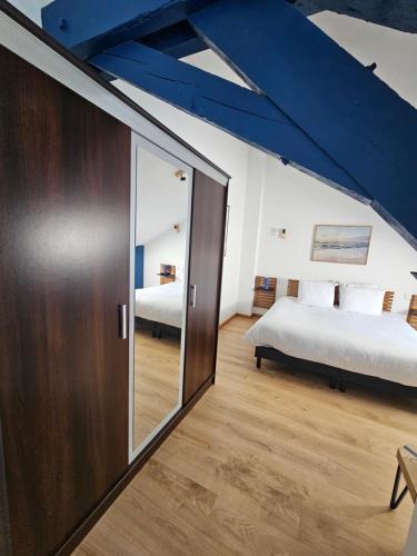a bedroom with two beds and a sliding glass door at Enjoy Garden in Vierzon