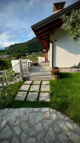 a walkway leading to a house with a patio at Casa al Molino - Il Nido in Drena