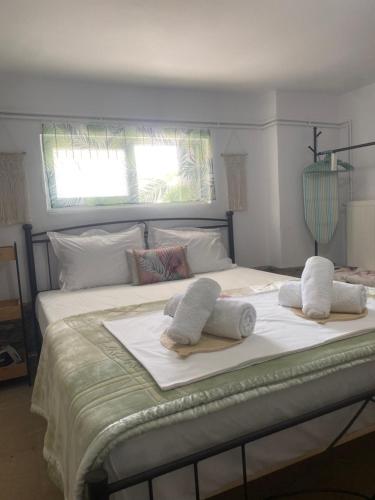 a white bed with towels on top of it at Studio Cleopatra in Kanali