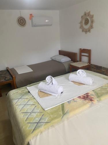a room with a bed with towels on it at Studio Cleopatra in Kanali