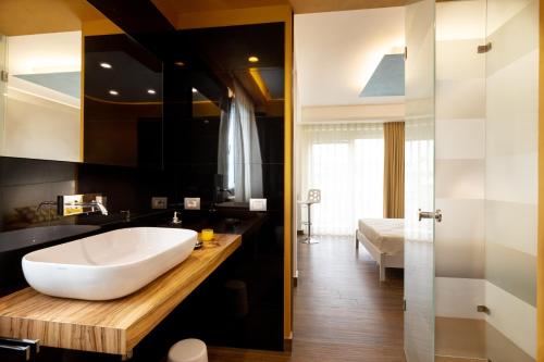 a bathroom with a large white tub on a wooden counter at Zaffiro Lavico rooms Etna nature sea in Acireale