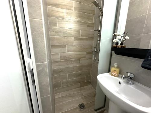 a bathroom with a shower and a sink at Colorsphere in Thessaloniki