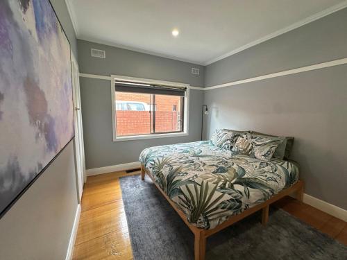 a bedroom with a bed and a window at Big home perfect for the whole group in Morwell