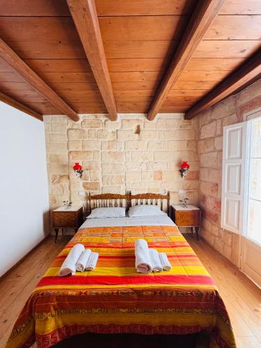 a bedroom with a large bed with wooden ceilings at Casa Vacanze Moonlight in Polignano a Mare