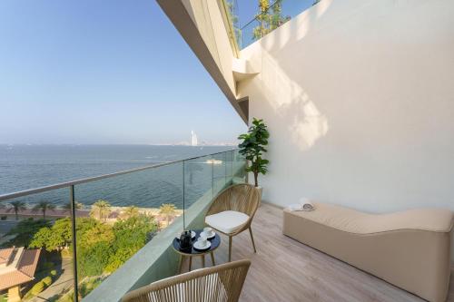 a balcony with a view of the ocean at Dejaview Stays Luxury Apartment with Private Terrace, Burj & Sea View in Dubai
