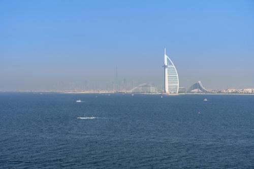 a large body of water with a building in the background at Dejaview Stays Luxury Apartment with Private Terrace, Burj & Sea View in Dubai
