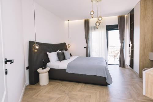 a bedroom with a large bed and a large window at Azanti Residence in Ulcinj