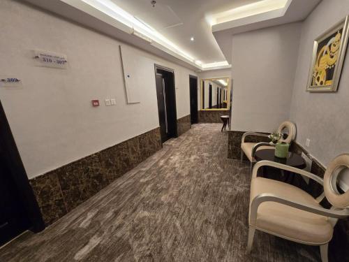 a waiting room with a row of chairs in a hospital at Ekono Hotel in Jeddah