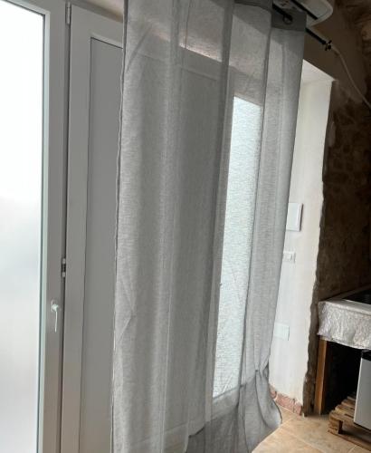 a curtain on a window in a room at La grotta in Vieste