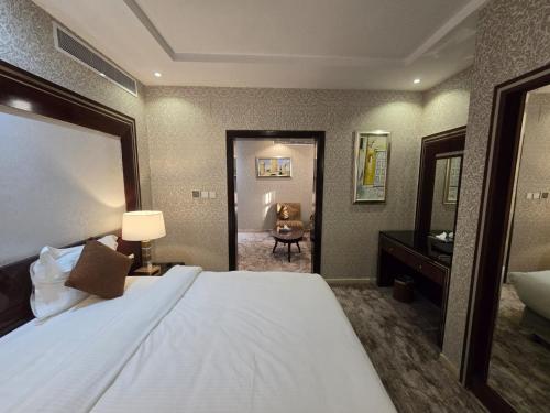 a hotel room with a large bed and a bathroom at Ekono Hotel in Jeddah