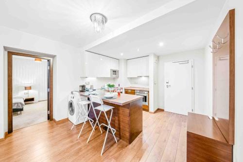 a kitchen and living room with a table and chairs at Parkview apartment 52m2 in Hradiště