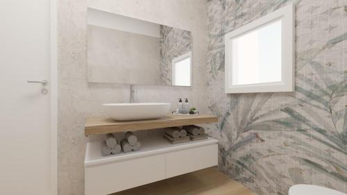 a bathroom with a sink and a mirror at Jesolo Fronte Mare Pineta - Jl Blue Apartments C5 in Lido di Jesolo