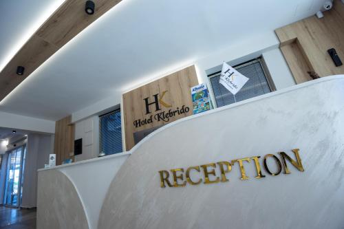 a reception desk with a sign that reads reception at Klebrido Hotel and Restaurant in Durrës