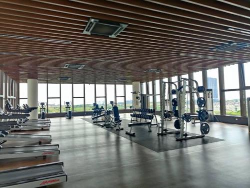 a gym with rows of exercise bikes and treadmills at Luxury & Comfy studio in the heart of Melaka in Melaka