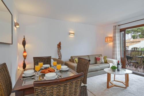 a living room with a table and a couch at Carmencita in Moraira