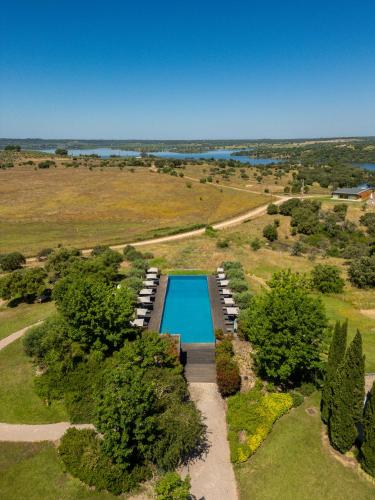an overhead view of a swimming pool in a field at Herdade da Cortesia Hotel in Avis